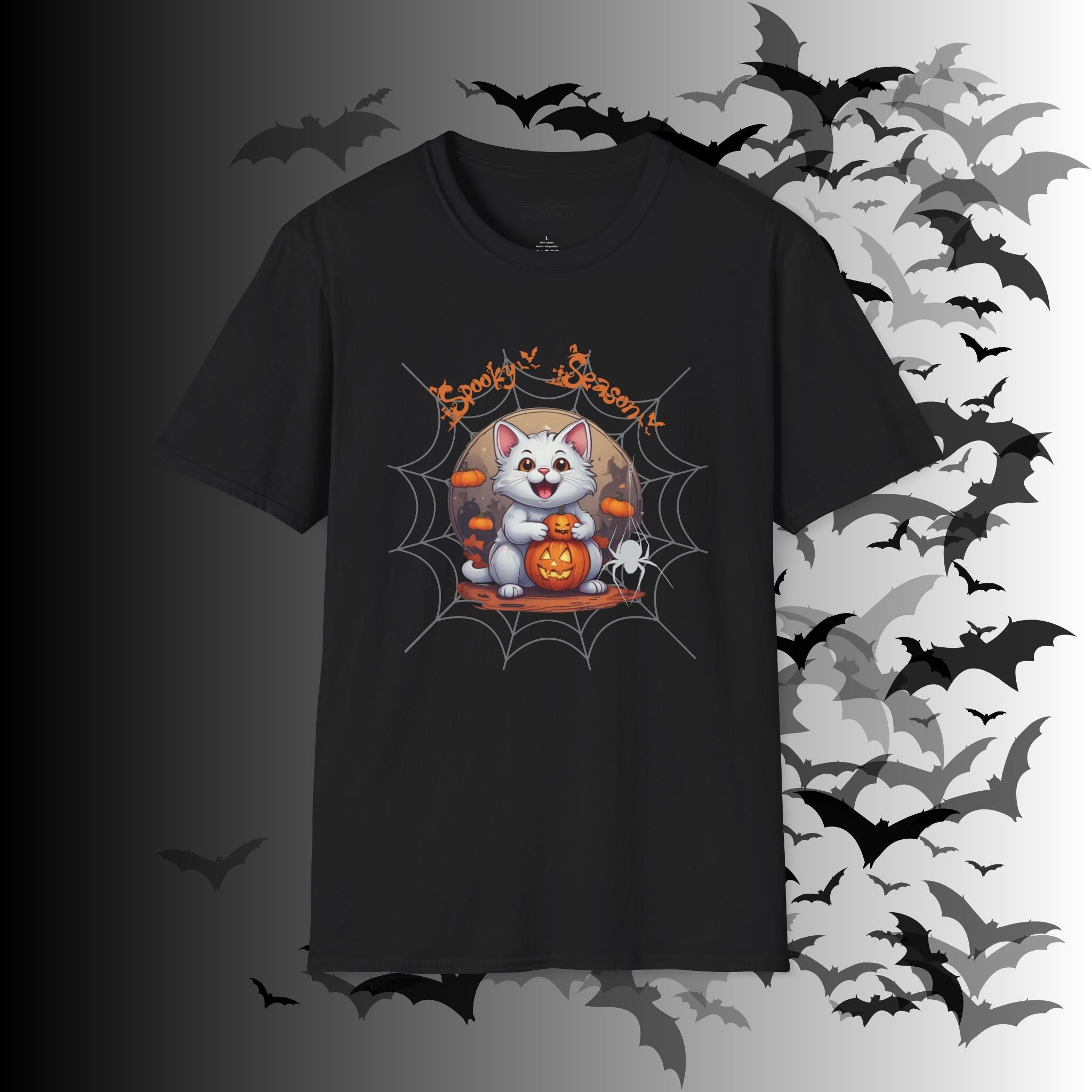Black t-shirt with kawaii white cat holding a jack-o-lantern inside a spider web frame with full moon and "Spooky Season" orange lettering above