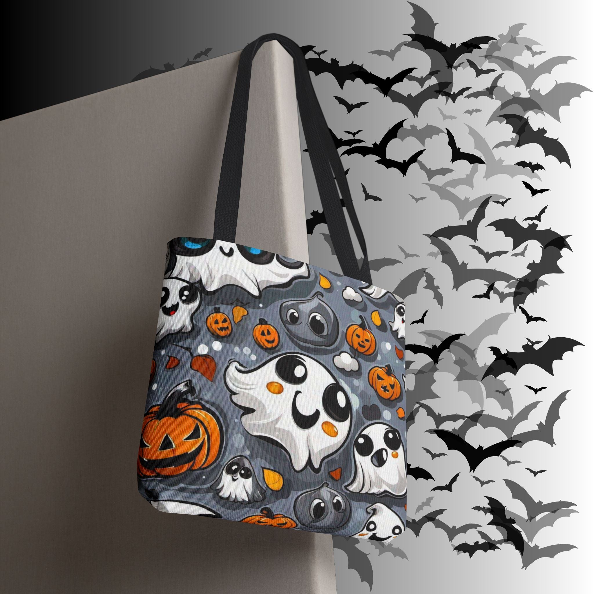 Grey polyester tote bag with multiple kawaii ghost characters, orange jack-o'-lanterns, and candy corn accents on a swirling cloud background