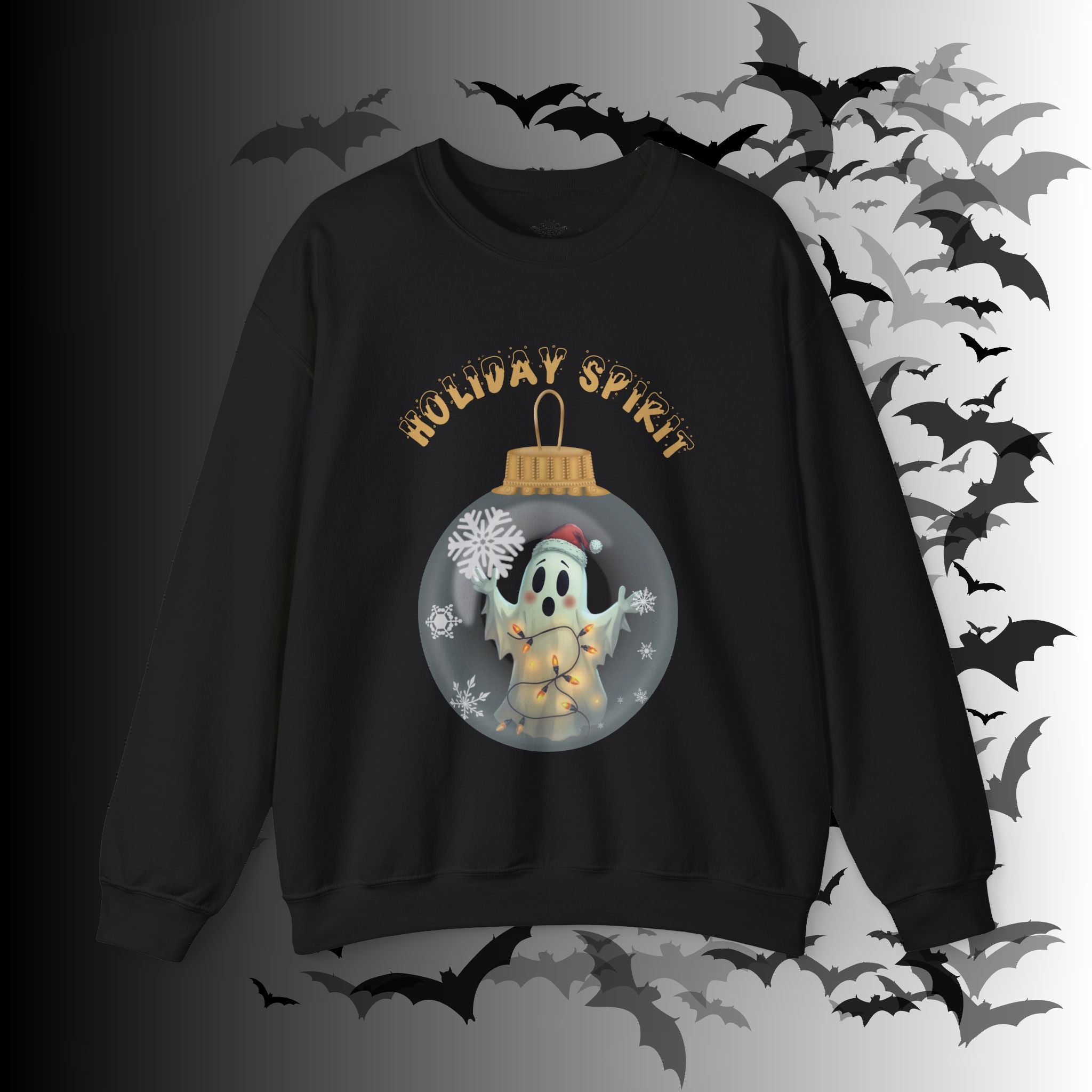 
Black crewneck sweatshirt with a kawaii ghost in a Santa hat wrapped in fairy lights inside a glass Christmas ornament with snowflakes and "Holiday Spirit" in gold gothic lettering on a bat-filled background