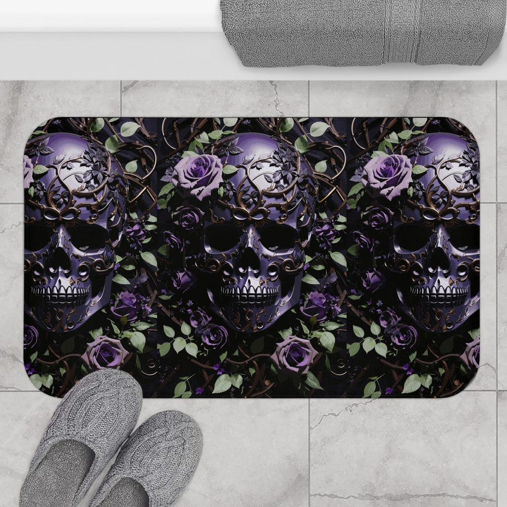 Gothic bath mat with three ornate purple skulls with gold filigree surrounded by violet roses, green leaves, and bronze vine scrollwork on a deep black background displayed on marble tile flooring