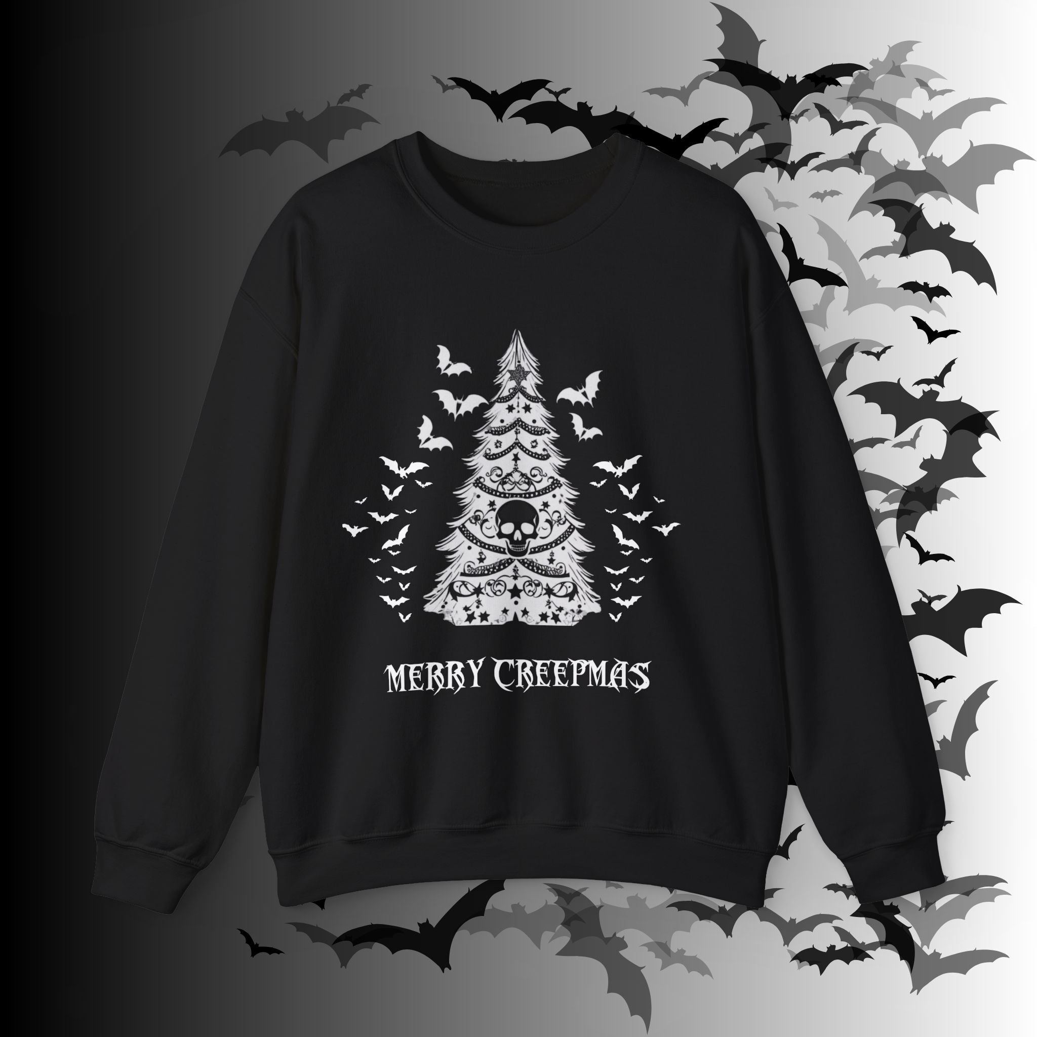 Black crewneck sweatshirt with white linework gothic Christmas tree decorated with a skull, garland chains, stars, and swarming bats with "Merry Creepmas" gothic lettering below on a bat-filled background