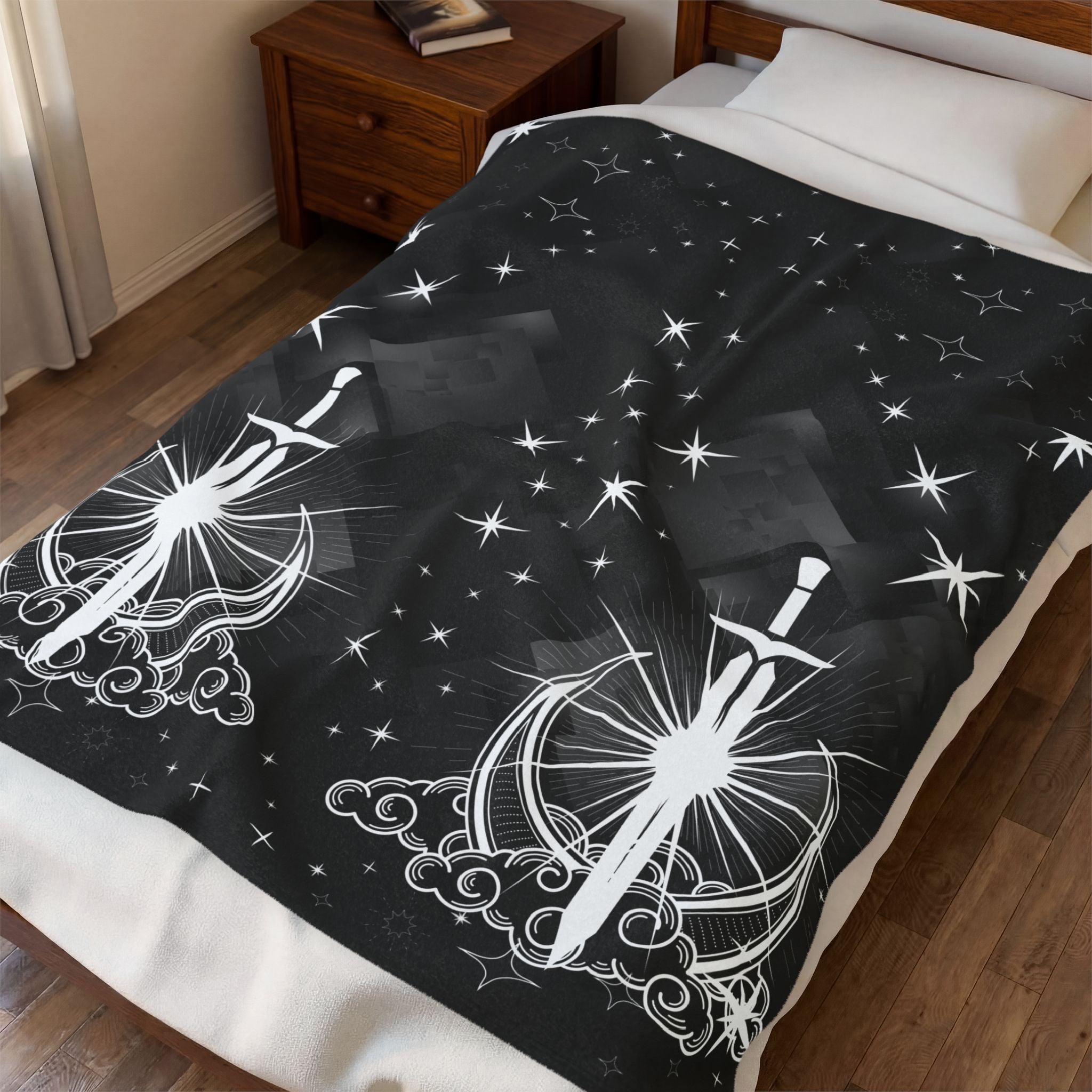 Black throw blanket with mirrored white sword and crescent moon motifs rising from ornate clouds with starburst rays and scattered star patterns against a deep black geometric starfield background