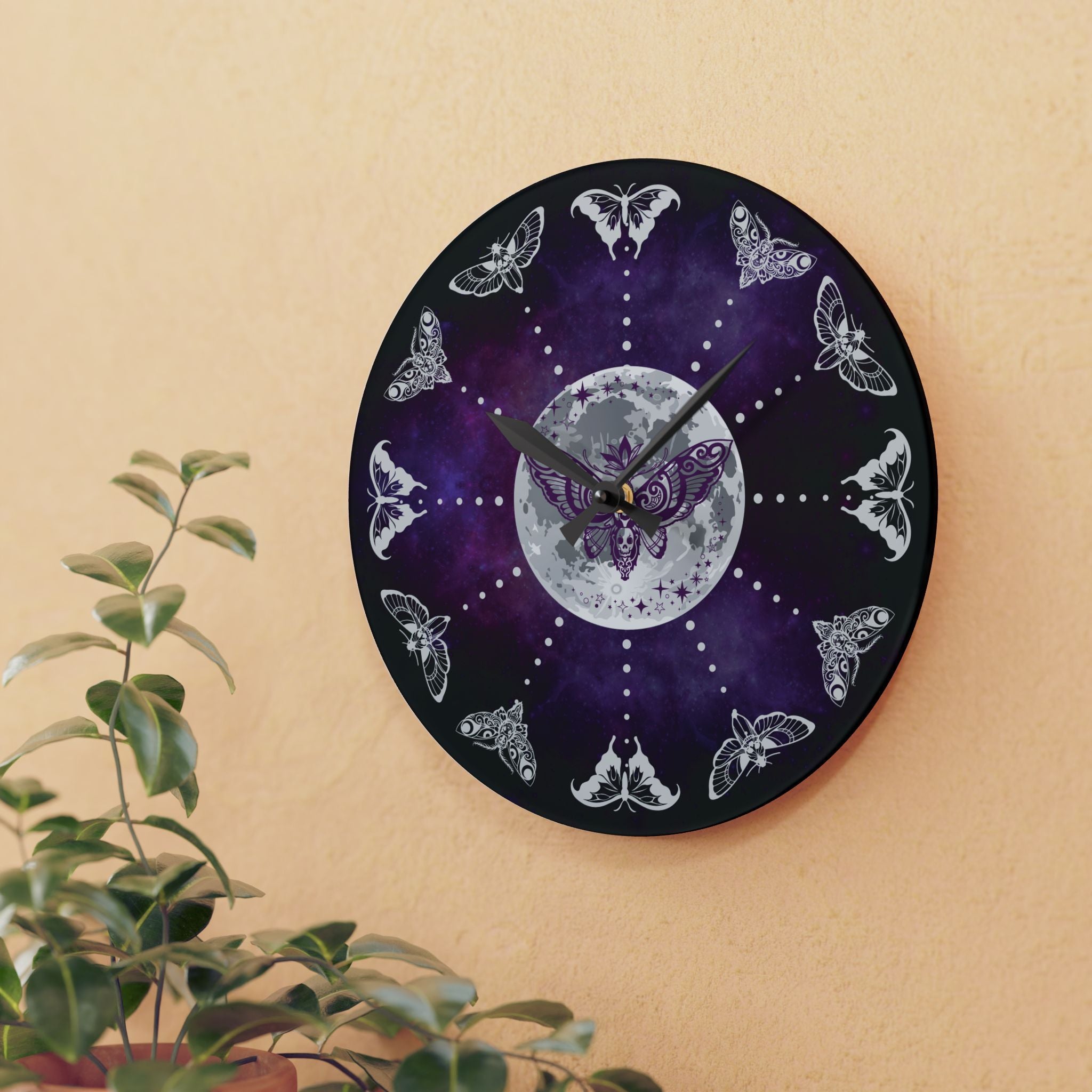 Round acrylic wall clock featuring twelve unique moth and butterfly silhouettes in white linework as hour markers around a glowing full moon center with a purple death's head skull moth and deep purple galaxy nebula background with black hour and minute hands