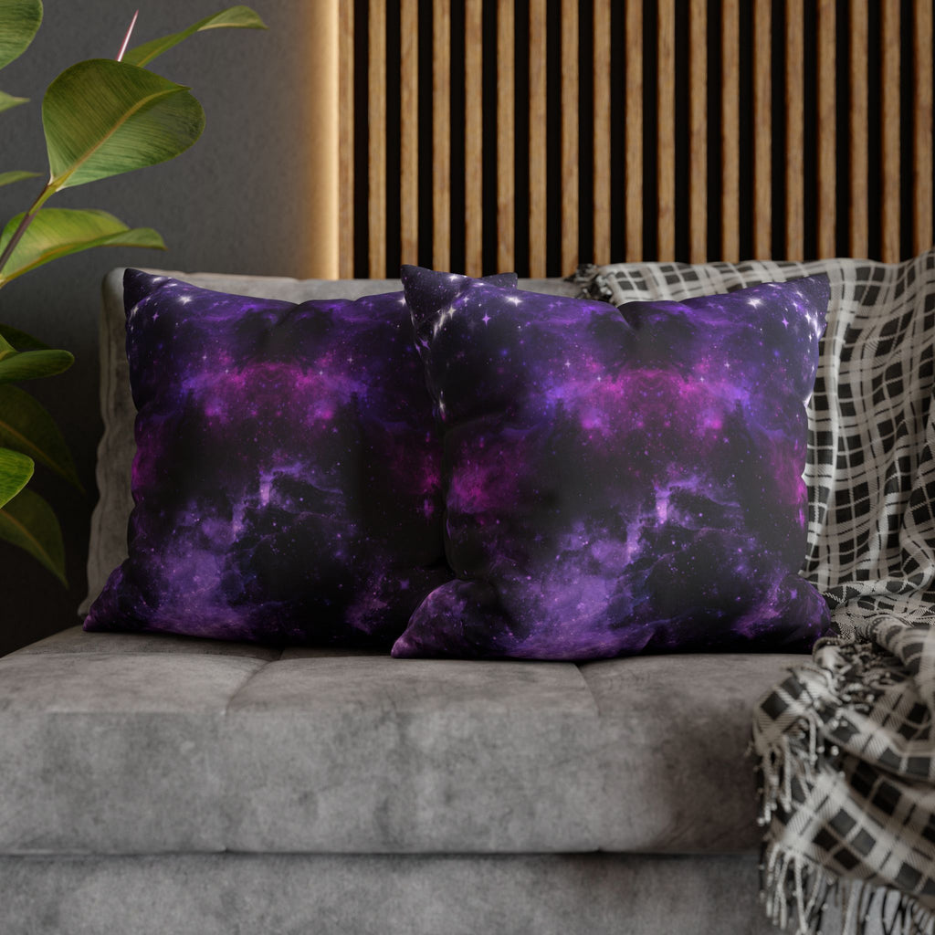 Two square throw pillows on a grey sofa featuring a deep space nebula design in swirling electric violet and magenta cosmic clouds shifting from near-black edges to bright purple and pink center with scattered white starburst sparkles