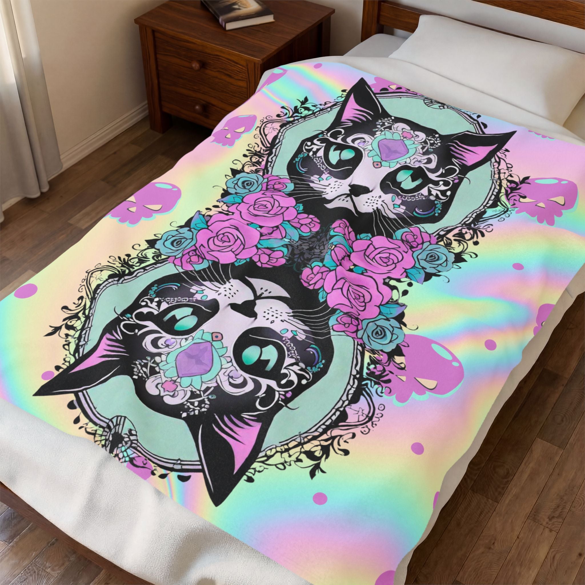 Throw blanket with two large sugar skull cats in black linework with teal gem eyes and intricate filigree, surrounded by hot pink and teal roses against a holographic pastel rainbow background shifting from mint to pink to gold