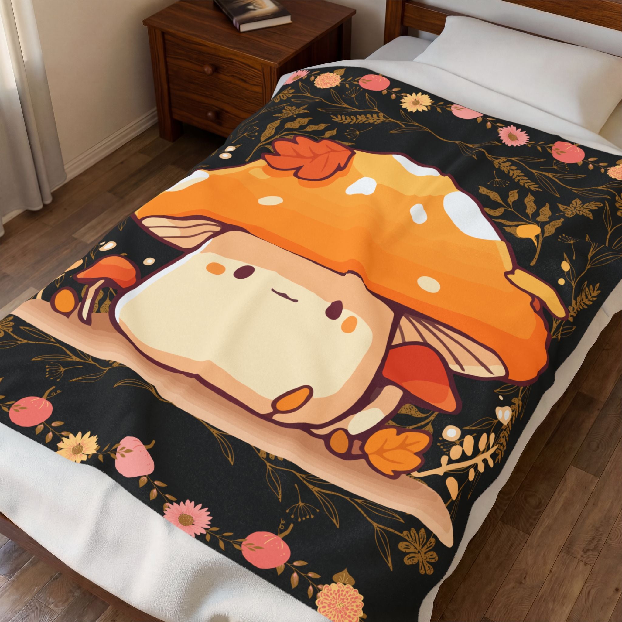 Black throw blanket with large kawaii mushroom character surrounded by smaller mushrooms, autumn leaves, and gold botanical borders with pink pumpkins and daisies