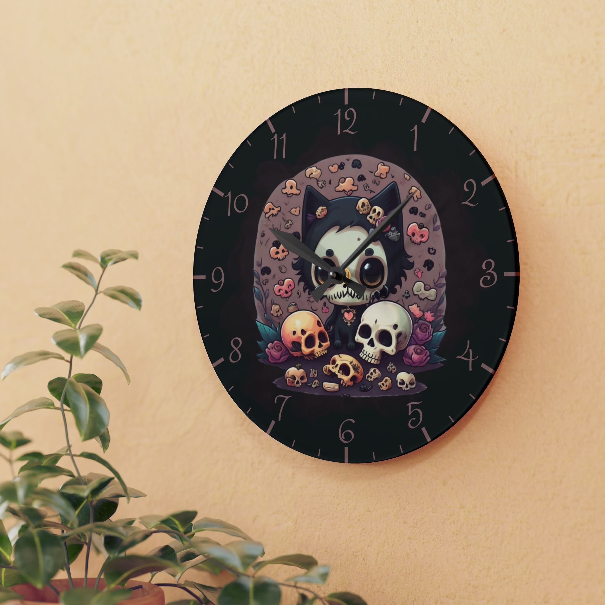 Round acrylic wall clock featuring a wide-eyed kawaii black cat with a skull face and heart charm surrounded by scattered skulls purple roses and teal leaves against a soft mauve moon backdrop with dusty rose Arabic numerals on a deep dark dial and black hour and minute hands