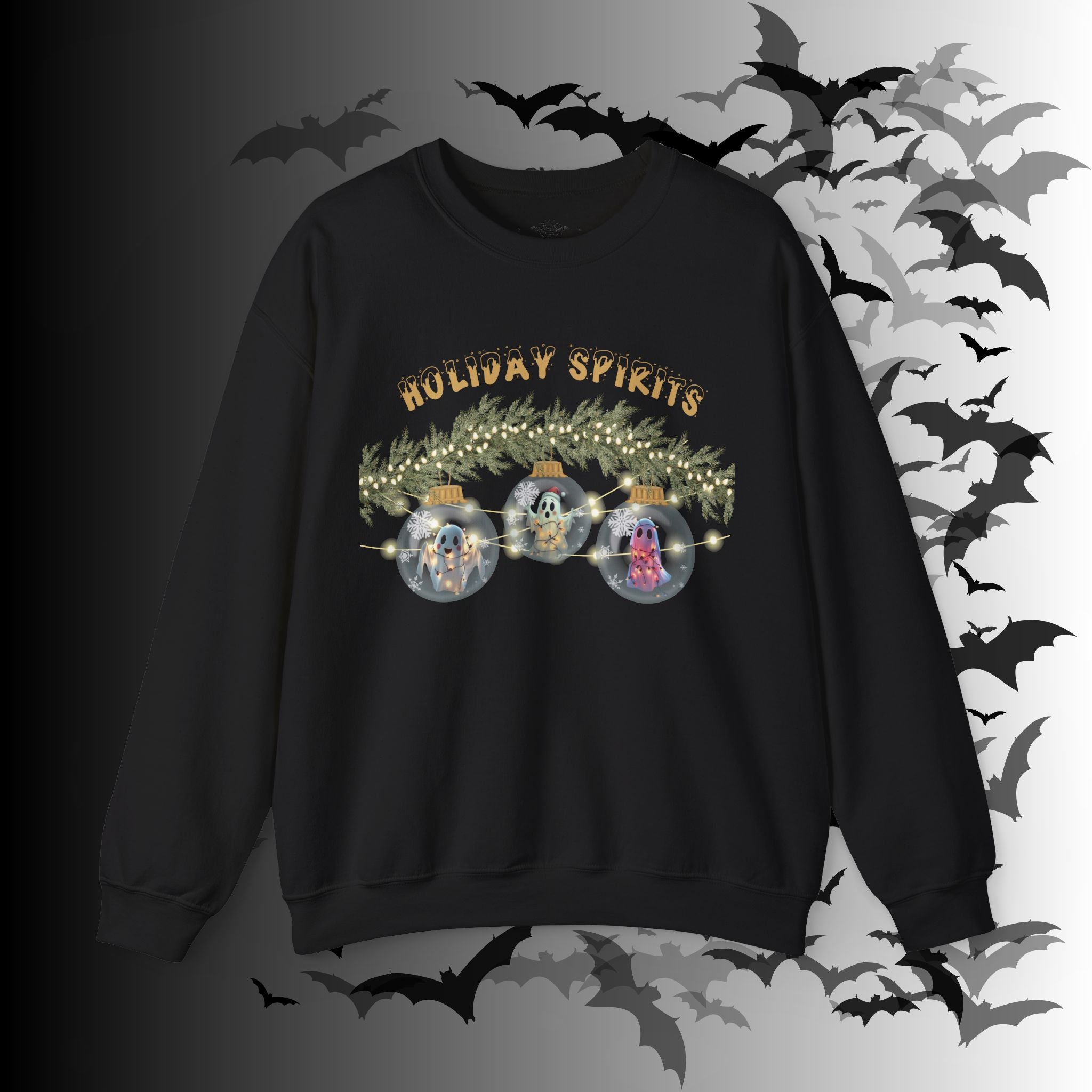 
Black crewneck sweatshirt with three kawaii ghosts inside glass Christmas ornaments hung from a pine garland with string lights and "Holiday Spirits" in gold gothic lettering on a bat-filled background