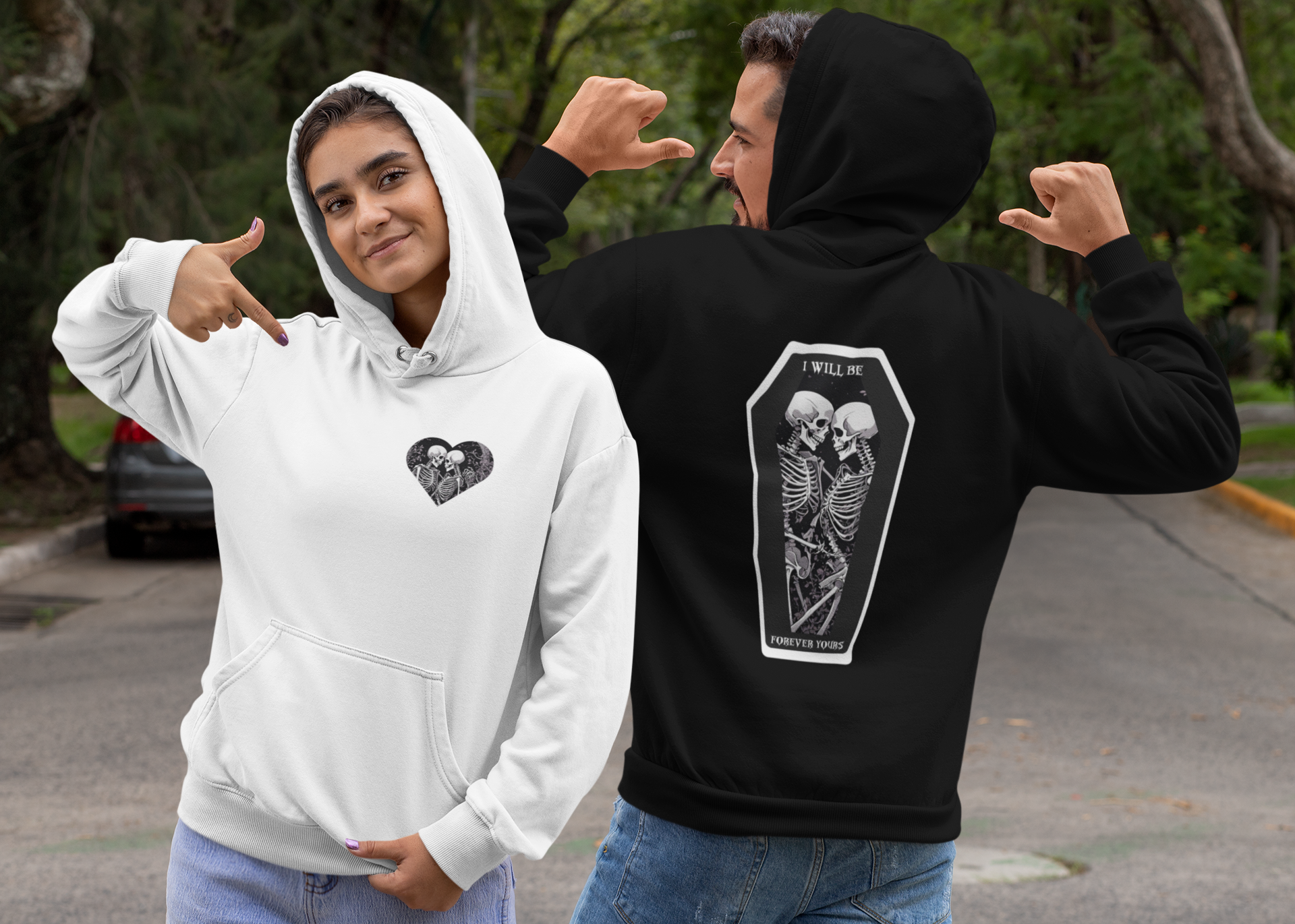 Black and white pullover hoodies front and back with skeleton heart chest print and two skeletons in a coffin with "I Will Be Forever Yours" back graphic