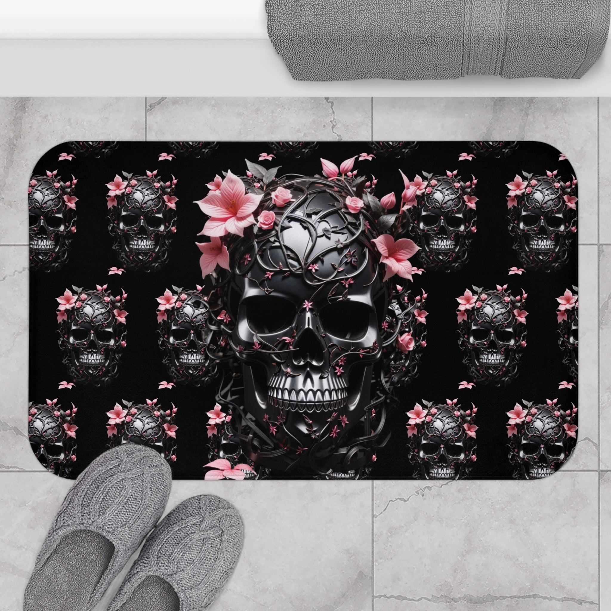 Gothic bath mat with repeating glossy black filigree skulls crowned with pink tropical blooms and roses on a deep black background