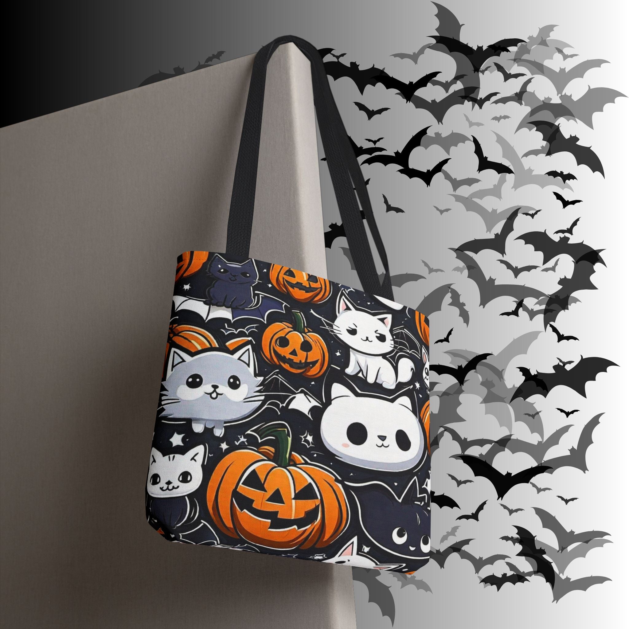 Dark polyester tote bag with multiple kawaii cat characters including grey, white, black, and skull-faced cats among jack-o'-lanterns and bat silhouettes