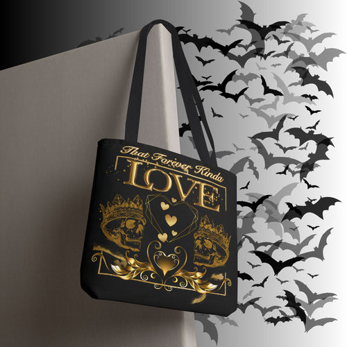 Black polyester tote bag with gold gothic design featuring twin crowned skulls, geometric heart, floating hearts, filigree scrollwork, and "That Forever Kinda Love" text