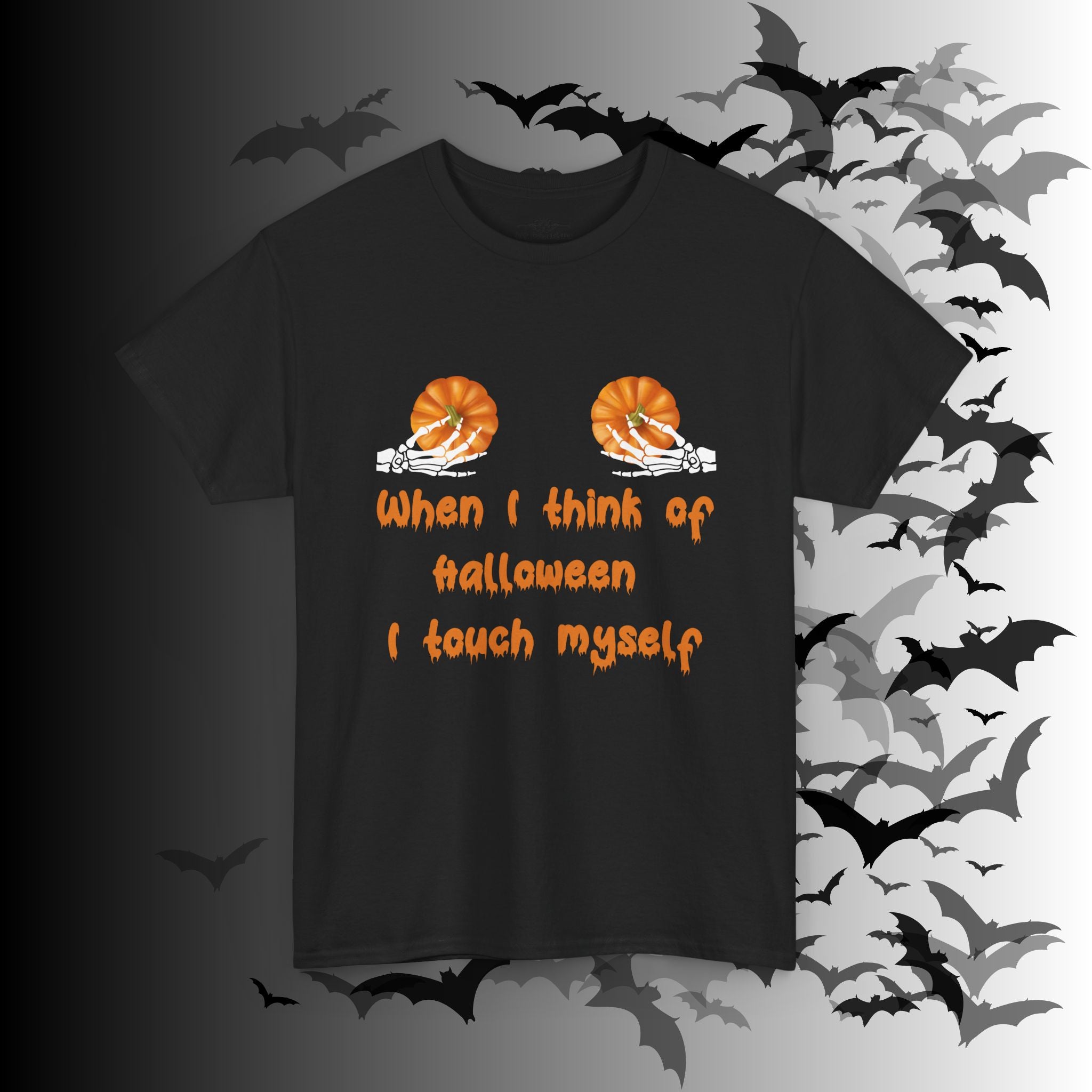 Black t-shirt with two skeleton hands each holding a pumpkin on the chest with "When I Think of Halloween I Touch Myself" in orange dripping lettering below