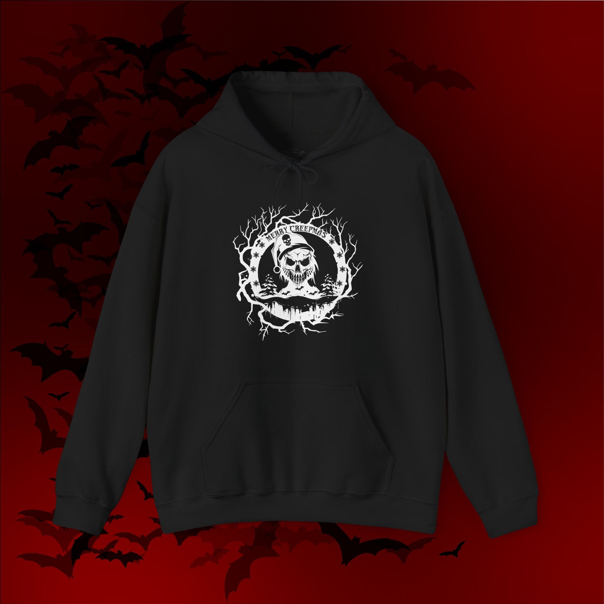 Black pullover hoodie with white linework skull Santa in a dead branch wreath with pine trees, snowflakes, and "Merry Creepmas" text on a red bat-filled background