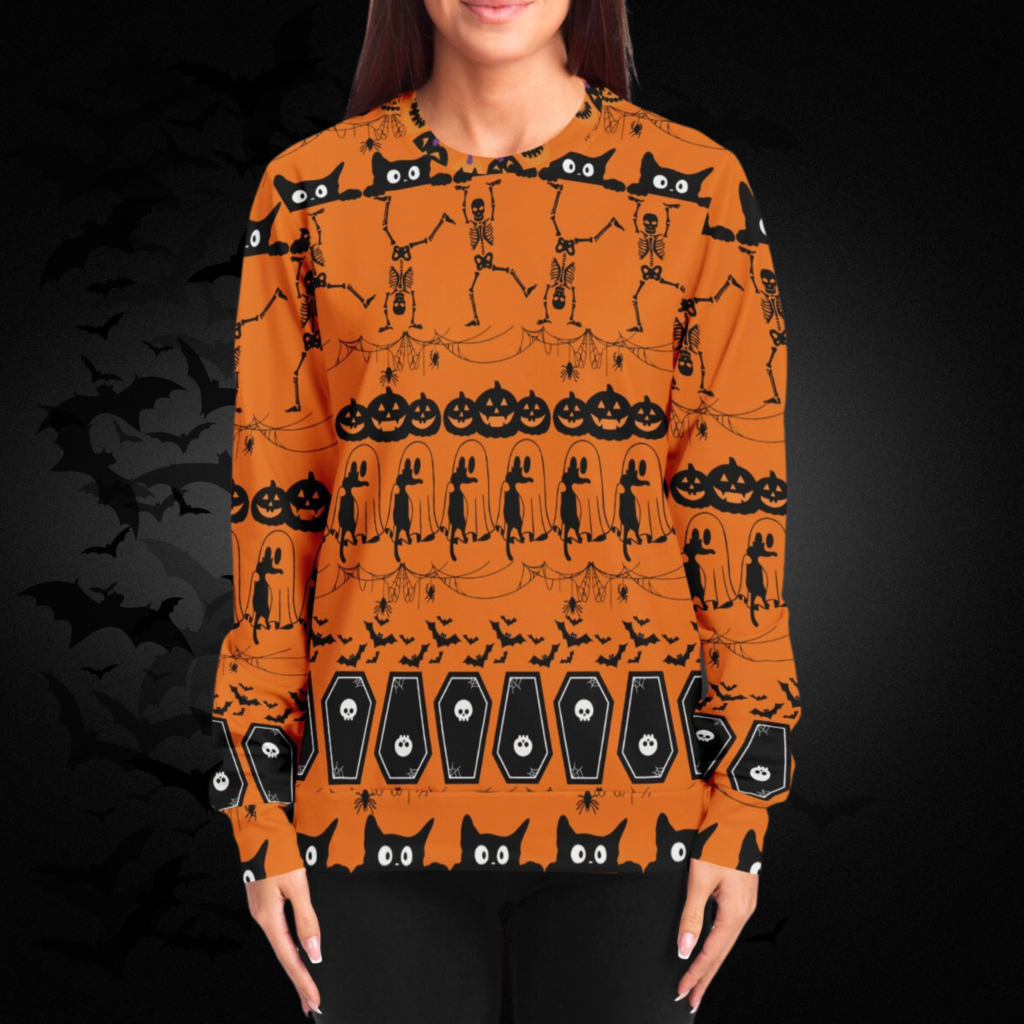 Person wearing an orange Halloween-themed sweater with black patterns on a dark background.