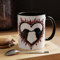  ceramic mug with two ravens facing each other inside a white heart bordered by jagged crimson thorn and flame detailing with a small red heart at the top