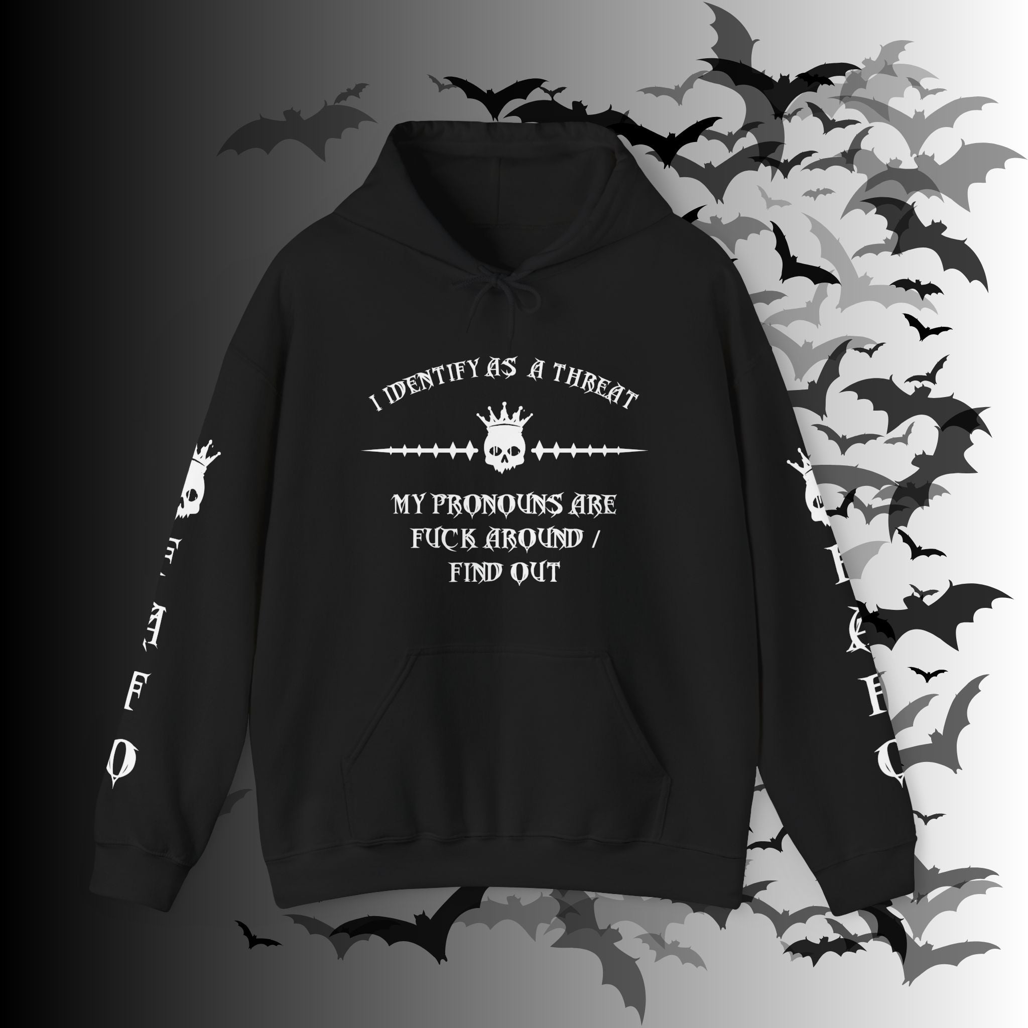 Black pullover hoodie with white gothic crowned skull graphic and "I Identify As a Threat — My Pronouns Are Fuck Around / Find Out" text with matching skull and FAFO sleeve prints on both arms on a bat-filled background