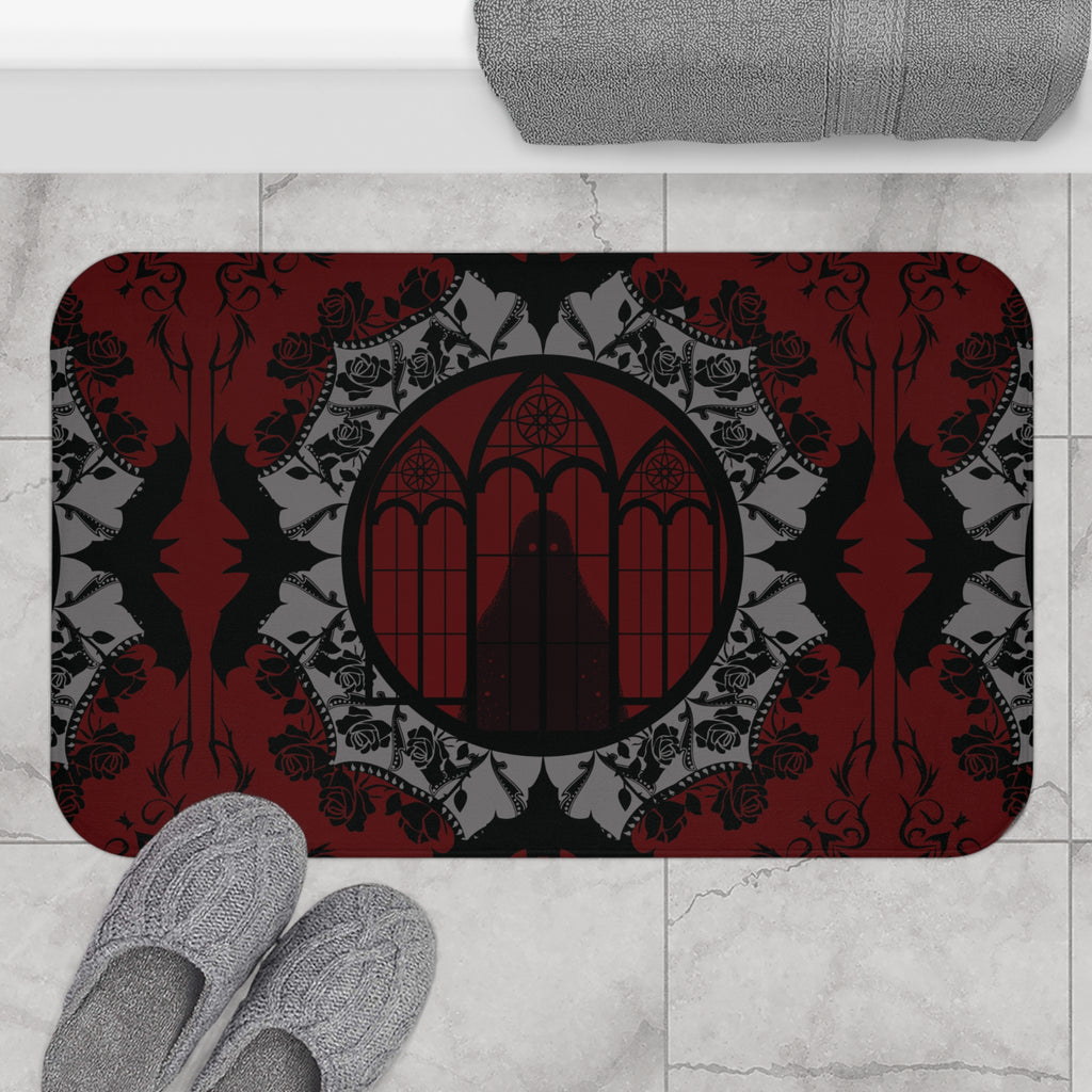 Gothic bath mat with a shadowy cloaked figure before cathedral windows centered in a grey bat and rose mandala on a deep crimson background with black roses and bat silhouettes displayed on marble tile flooring