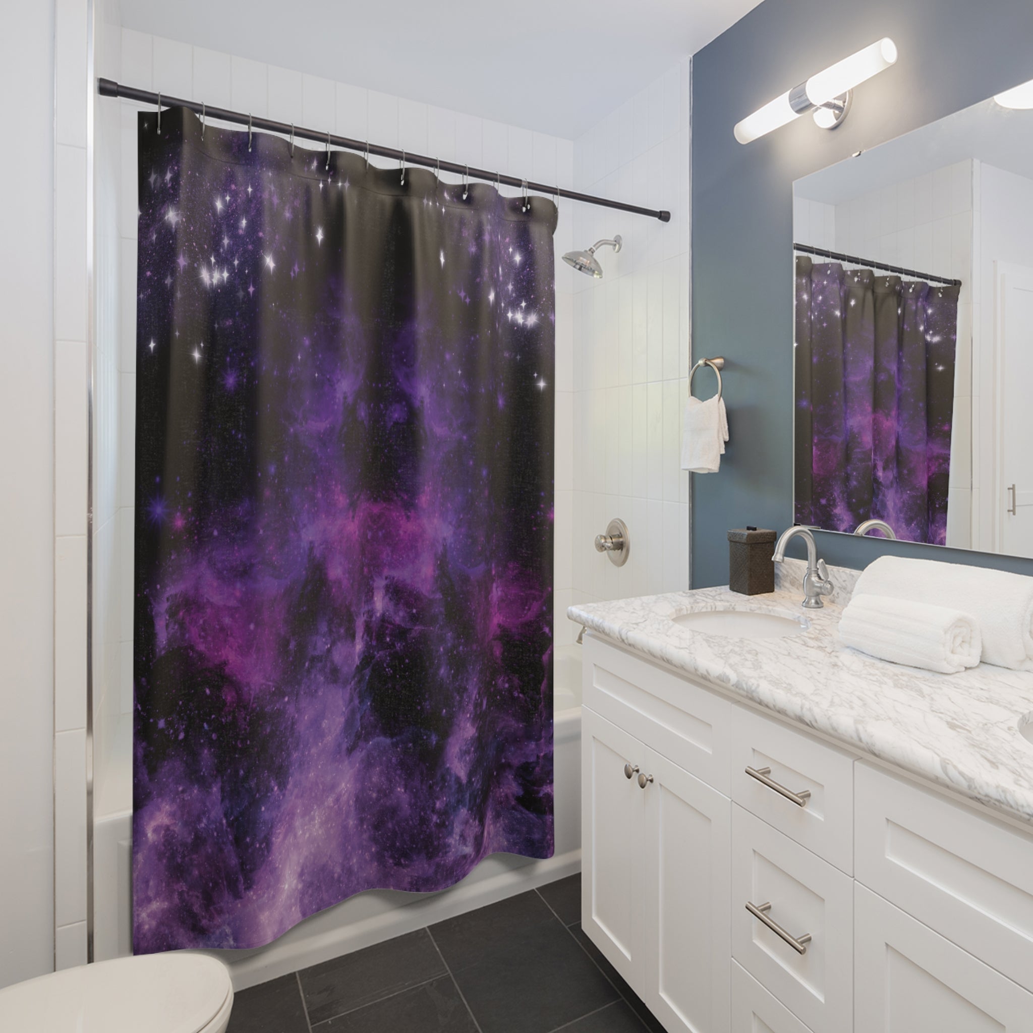 Pastel goth shower curtain with deep space nebula in swirling violet, magenta, and black with scattered white stars displayed in a white bathroom