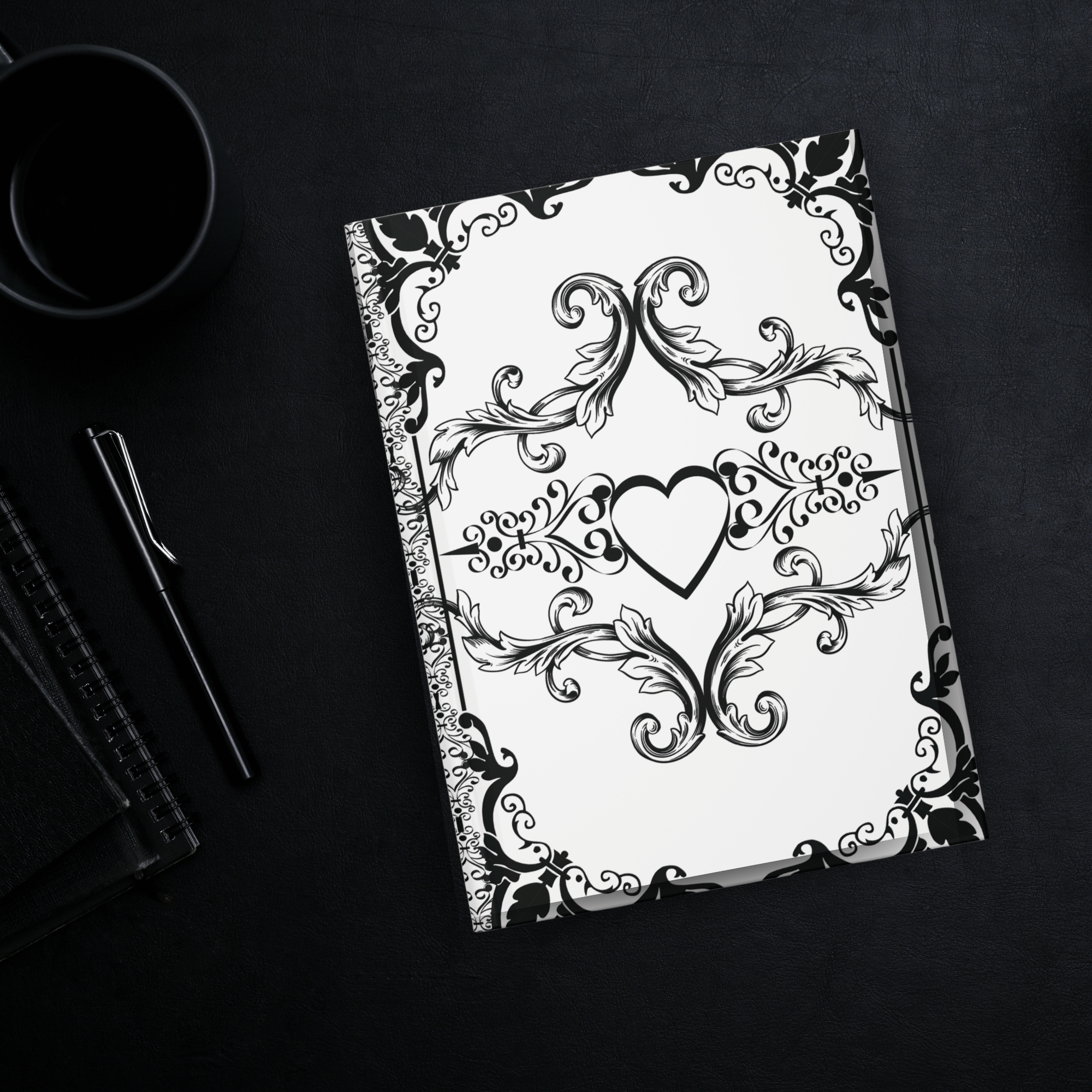 Gothic hardcover journal with black Victorian baroque scrollwork and hearts on an ivory white background